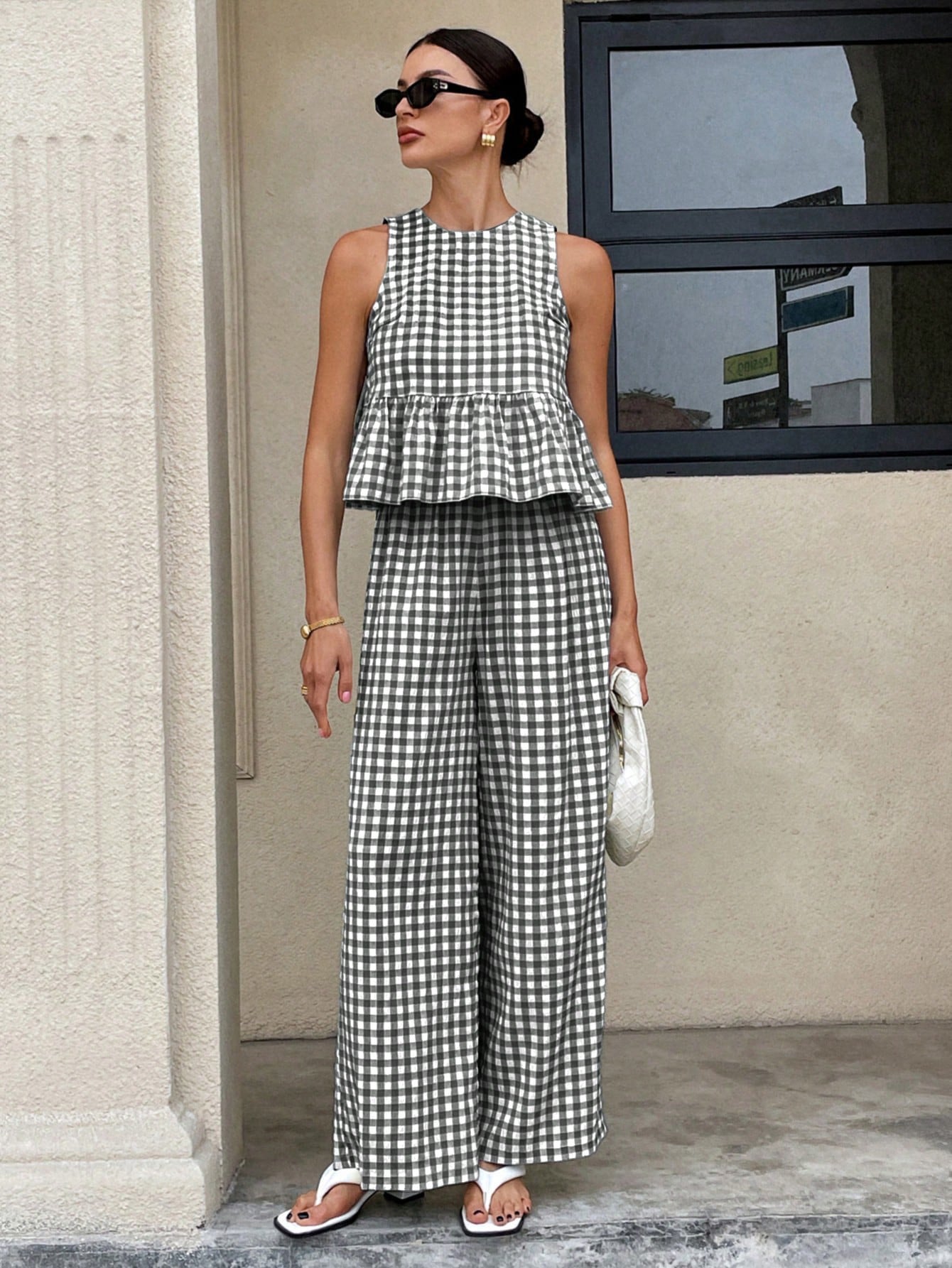 Top da donna casual senza maniche con scollo rotondo e orlo a balze, abbinato a pantaloni a gamba dritta.